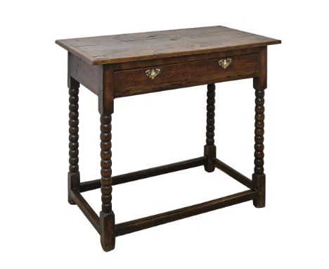 An 18th century oak side tablethe well figured cleated three plank top over a single drawer with later small brass swan's nec