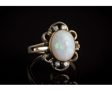 A vintage 14ct yellow gold, opal and diamond ring1970s, the oval cabochon opal within a floral style openwork border set with