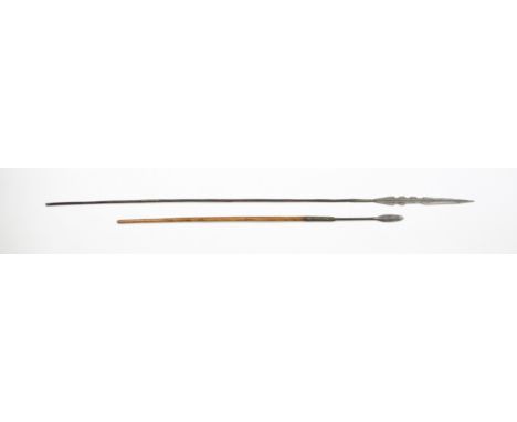 An African tribal spear19th century, hand forged shaped tip with lift over collar, on ebonised wooden shaft, spiralling metal