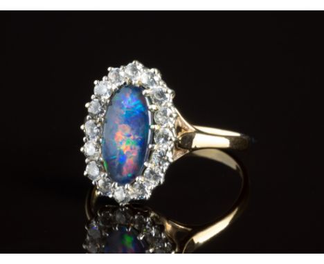 A 9ct yellow gold, opal triplet and CZ cluster ringthe oval cabochon triplet opal within a border of CZ stones, ring size X.