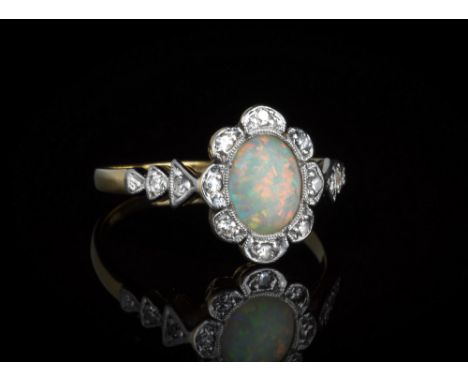 An antique 18ct gold and platinum, opal and diamond cluster ringthe oval cabochon opal within a floral border millegrain set 