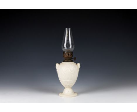 A Parian / biscuit porcelain oil lamp by Copelandfoliate design throughout, with mask to either side, overall height 12.5in. 