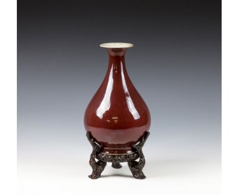 An 18th century Chinese Sang-de-Bouef glazed porcelain bottle vase the teardrop shaped body rising to a short neck and strong