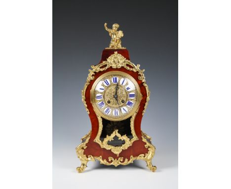 A 19th century tortoiseshell and gilt metal mantel clockwith French style Roman enamel numerals, gilt dial, sun pendulum, the