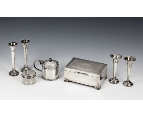 An Elizabeth II silver cigarette boxHarman Brothers, Birmingham 1961, engine turned decoration, raised on bracket feet; toget