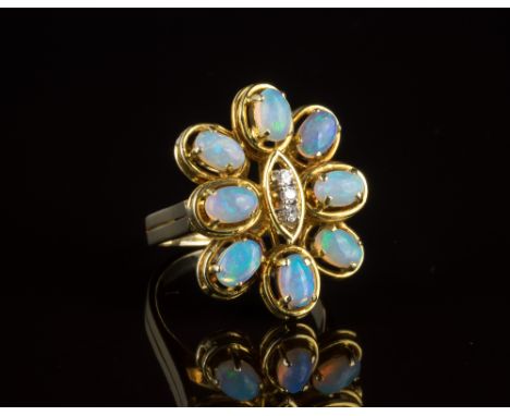A vintage 14ct yellow gold, opal and diamond floral ring1970s, the eight cabochon opals surrounding a central ellipse set wit