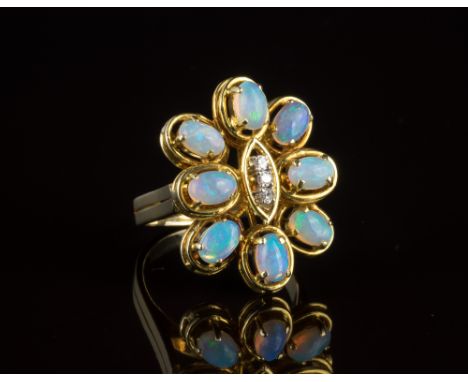 A vintage 14ct yellow gold, opal and diamond floral ring1970s, the eight cabochon opals surrounding a central ellipse set wit