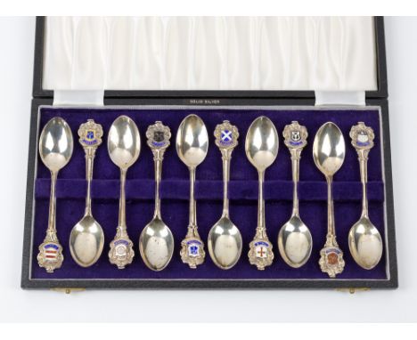 A cased set of ten silver and enamel teaspoons, depicting Guernsey parisheseach spoon with the parish shield and name, hallma