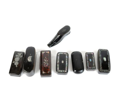 Four papier mache snuff boxes, each with inlaid mother of pearl decoration, together with a pique work snuff box in the form 