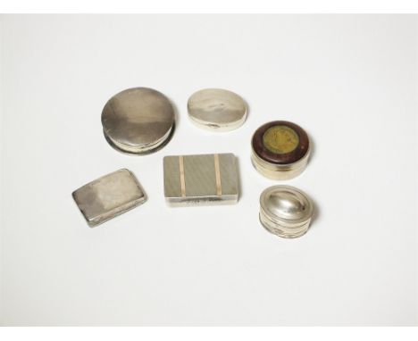 A circular silver box and cover, together with an engine turned silver box with hinged cover, an oval silver pill box with do