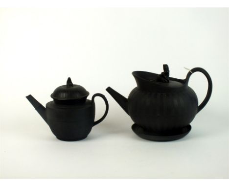 A Wedgwood black basalt teapot, cover and stand circa 1790, with engine-turned detail and the cover with Sybil knop, impresse