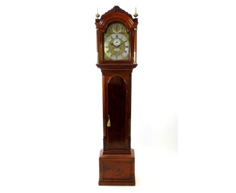 A George III longcase clock the arched hood with shaped pediment and two ball and spire finials above and arched glazed door 