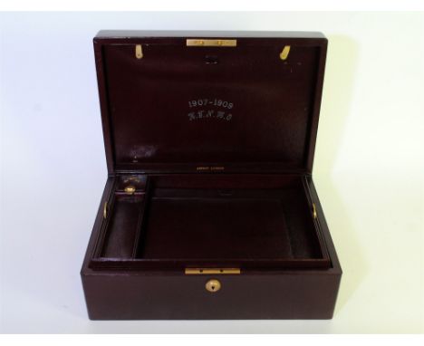 An Edwardian gentleman's travelling case by Asprey, in dark red leather, the rectangular hinged cover with inset central gilt