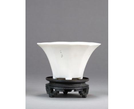 A Chinese Dehua libation cup Qing Dynasty, 18th/19th Century Of octagonal form and raised on four button feet, incised with a