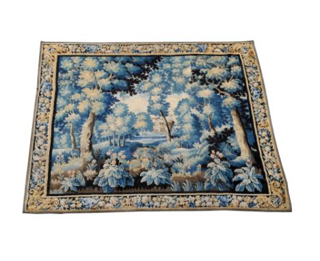 A French Aubusson tapestry, circa 1680, a verdure tapestry with two small figures harvesting in the centre within broad folia