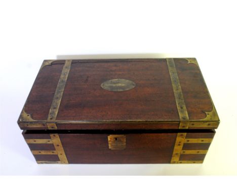 A mahogany and brass bound campaign desk, 19th century, the rectangular top with oval inset vacant tablet for a personal mono