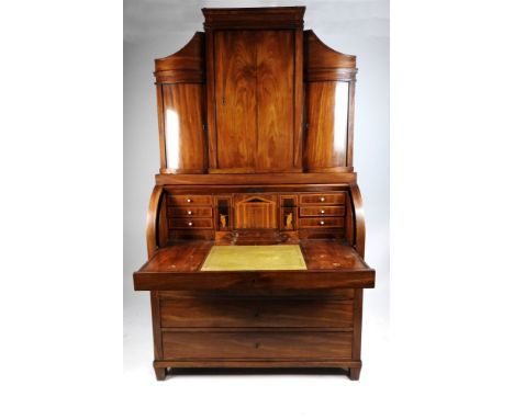 A 19th century Danish mahogany cylinder bureau, the break top with inset cornice above a panel cupboard door enclosing a rack