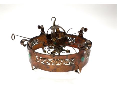 An Arts and Crafts copper light fitting circa 1900, fitted for electricity, on open round form with pierced ivy leaf border s