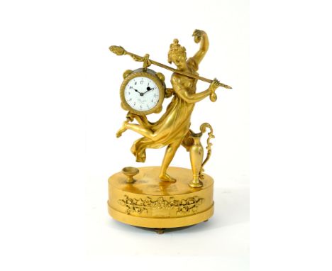 A French Empire ormolu novelty mantel time piece, modelled as goddess Erato, dancing with castanets and holding a golden staf