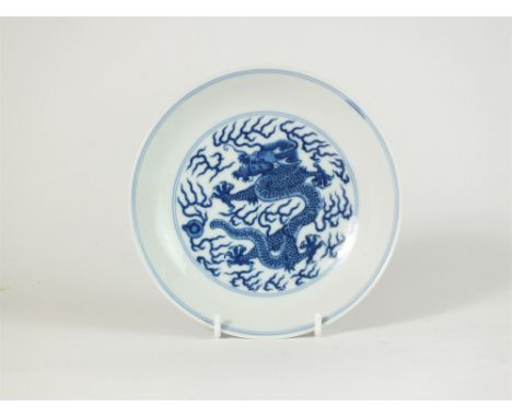 Chinese blue and white porcelain saucer dish, Qianlong seal mark, the well decorated with a scaly five clawed dragon amongst 