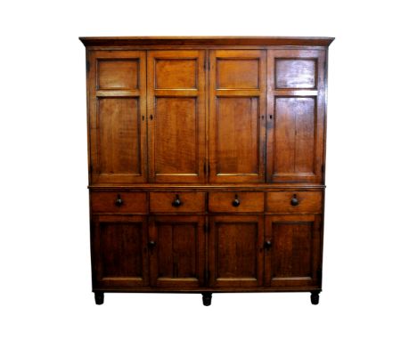 A Regency oak and ebony strung house keeper’s cupboard, early 19 th century, the canted cornice above four indented panel cup