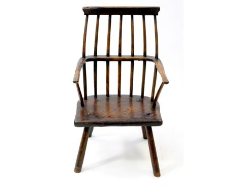 An elm and ash vernacular stick back chair, possibly Irish, early 19 th century, with yew wood top rail and traces of paint, 