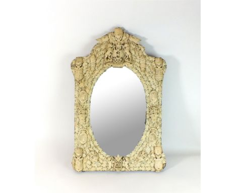 A French bone and ivory mirror, Dieppe, third quarter 19th century, in historical revival style, the bevelled oval plate with