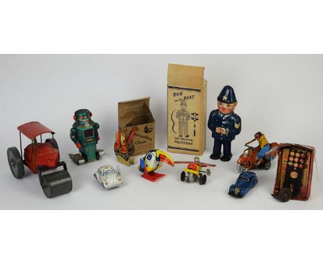 Tin Toys. A motorcycle and rider, Bob on the beat policeman, a Shuco car, a Somersaulting Clown, a VW Beetle ambulance, a cir