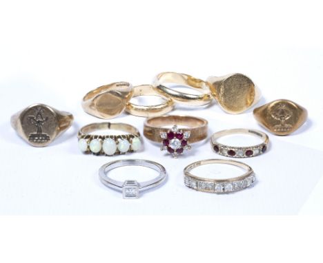 Collection of gold and yellow metal rings including two wedding bands stamped 14k, an opal ring, 9ct and 18ct gold signet rin