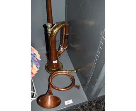 A selection of copper and brass horns including post carriage and bugle
