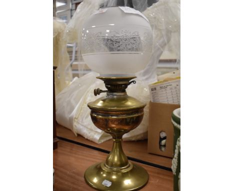 A vintage oil burning lamp having etched glass shade with damage