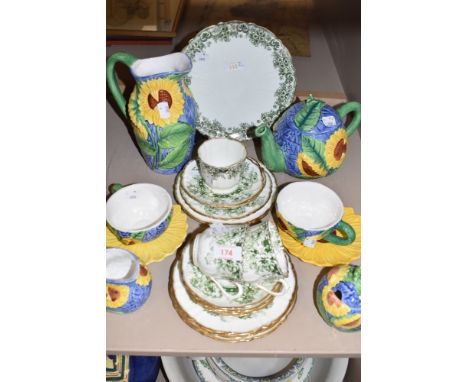 A part breakfast set having moulded sunflower design if blue ground including cups and saucers,preserve jar, jug and tea pot.