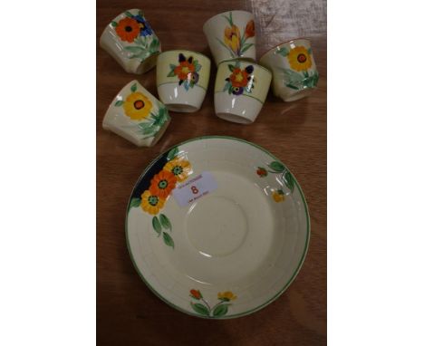 A selection of Clarice Cliff style ceramics hand painted with flowers including siz egg cups and one saucer stamped R