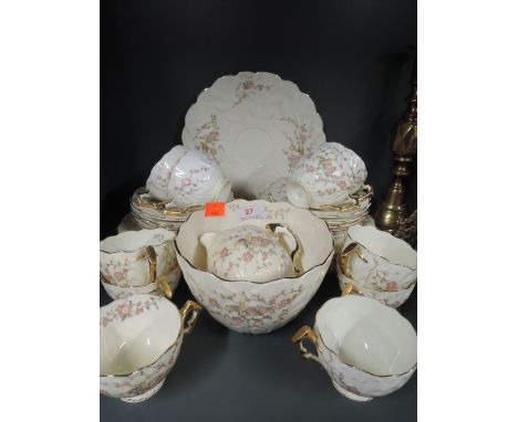 A vintage part tea service with hand decorated bird and flower design