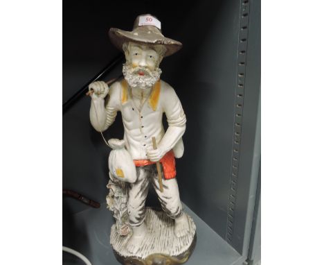 A ceramic figure of a gentleman of the road