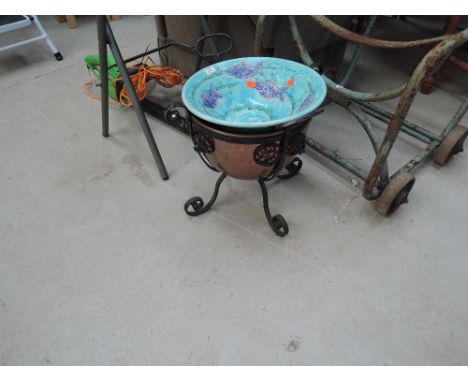 A copper and wrought iron bucket and ceramic bowl
