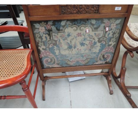 An oak framed fire screen with tapestry centre