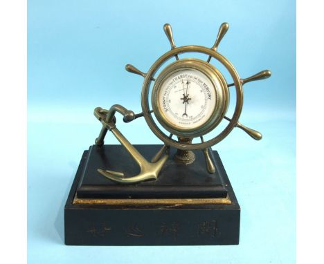 A late-19th century aneroid barometer in the form of a brass ship's wheel mounted together with an anchor, on a shallow marbl