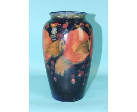 Moorcroft, a large vase of baluster form decorated in the Pomegranate pattern on a dark blue ground, 26cm high, impressed 'Mo