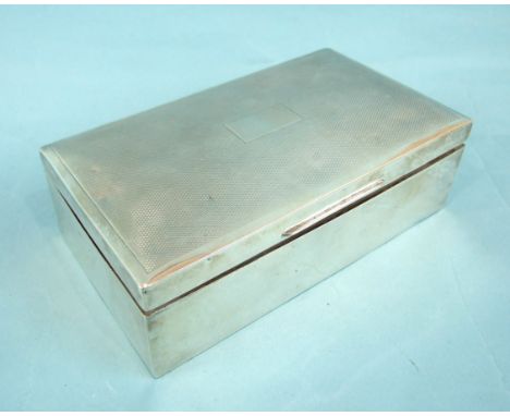 A rectangular engine-turned cigarette box, marks rubbed, 17cm.