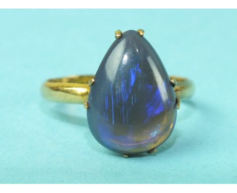 A yellow gold ring set pear-shaped black opal, (tested 18ct gold), size M, 3.1g.