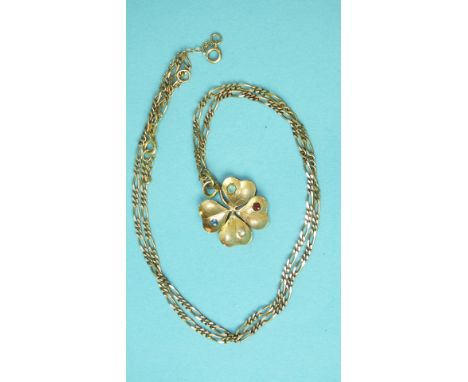 A gold four-leaf clover pendant set with a rose-cut diamond, sapphire, ruby and aquamarine, unmarked, tests as 15-18ct gold, 