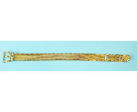 A Victorian gold flexible bracelet in the form of a belt, with turquoise and pearl-set buckle and slider, the 11mm wide strap