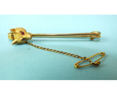 A 9ct gold bar brooch set fox's mask, with ruby eyes, 51mm long, 4.3g, (boxed).