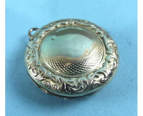 A small Victorian gold vinaigrette of circular form with engine-turned decoration, within chased raised border, unmarked, 26c