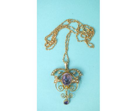 An Edwardian 9ct gold amethyst and seed pearl brooch/pendant of scrolling design, on later 10k gold chain, 6.9g.