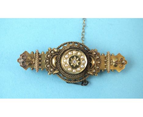 A Victorian 15ct gold brooch set diamond and pearl cluster, within cannetille decoration, 5.2g, cased.