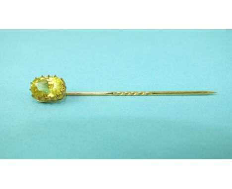 A stick pin claw-set a yellow chrysoberyl, in yellow gold mount, (tests as 18ct approximately), approximately 2.3cts, 1.8g.