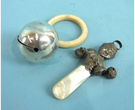 A late-Victorian baby's rattle in the form of a child's face, with four hanging bells and mother-of-pearl handle, 8cm, Birmin