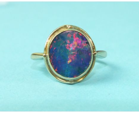 A synthetic black opal ring in 9ct gold mount, size M, 3.3g.